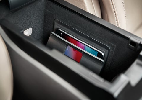 A smartphone device is securely tucked into the available wireless charging pad for an effortless energy boost | Fair Oaks Lincoln in Naperville IL