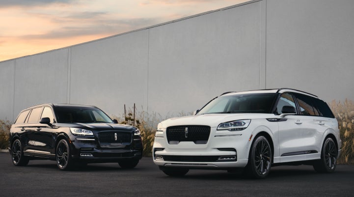 Two Lincoln Aviator® SUVs are shown with the available Jet Appearance Package | Fair Oaks Lincoln in Naperville IL